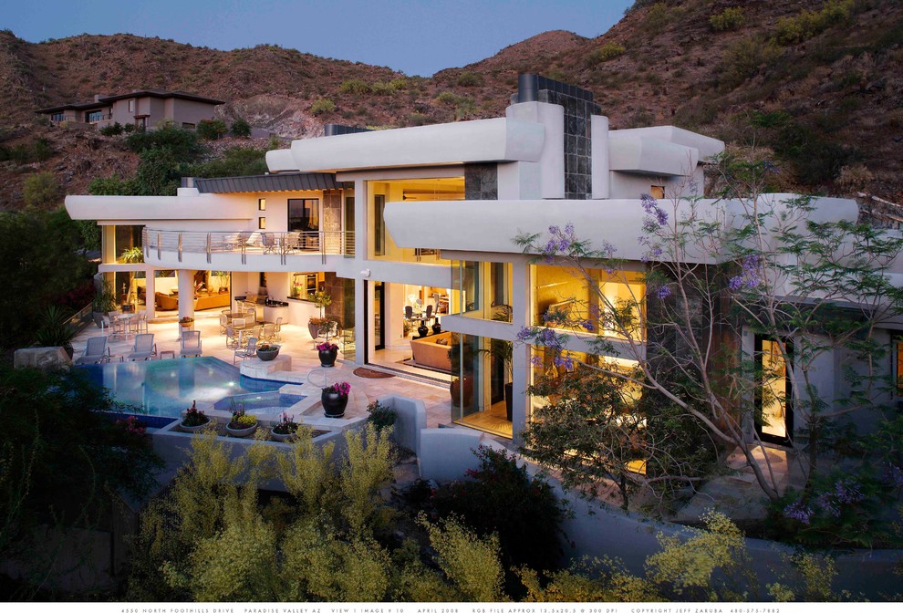 Design ideas for an expansive contemporary two-storey stucco grey exterior in Phoenix.