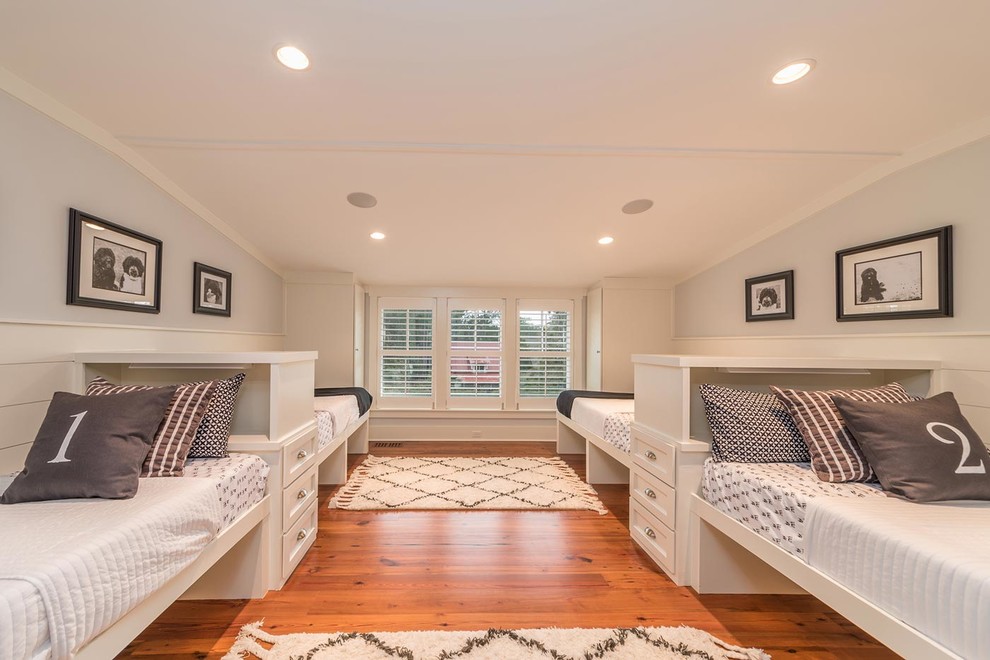 Large beach style gender-neutral kids' bedroom in Atlanta with grey walls, medium hardwood floors and brown floor.