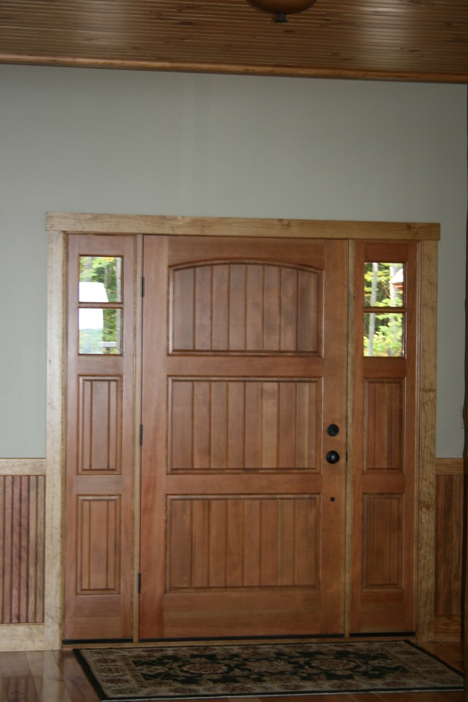 Front door - large rustic medium tone wood floor front door idea in Boston with beige walls and a medium wood front door