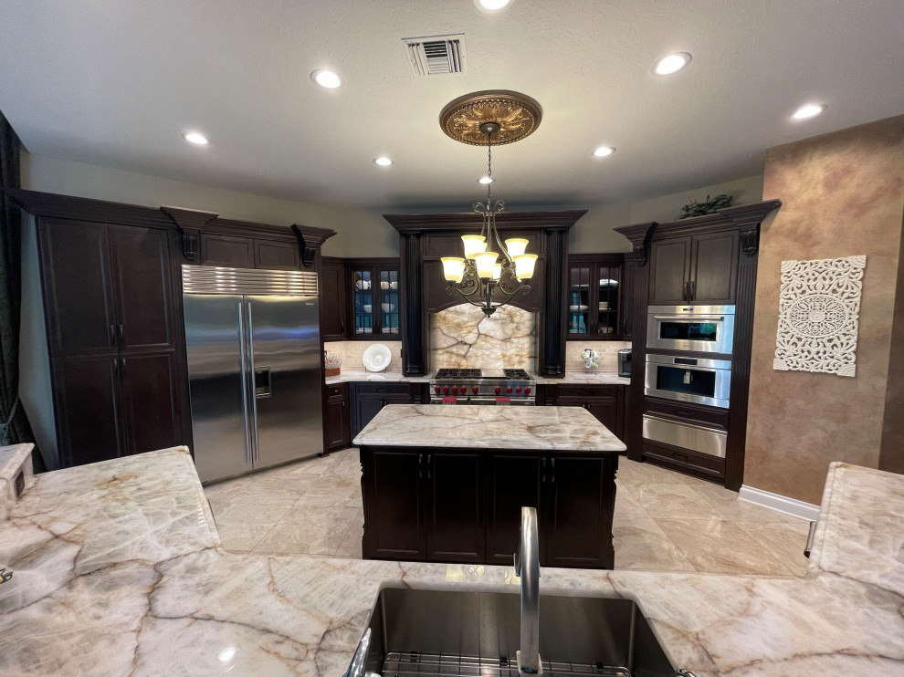 Inspiration for a large modern kitchen/diner in Tampa with dark wood cabinets, quartz worktops and an island.