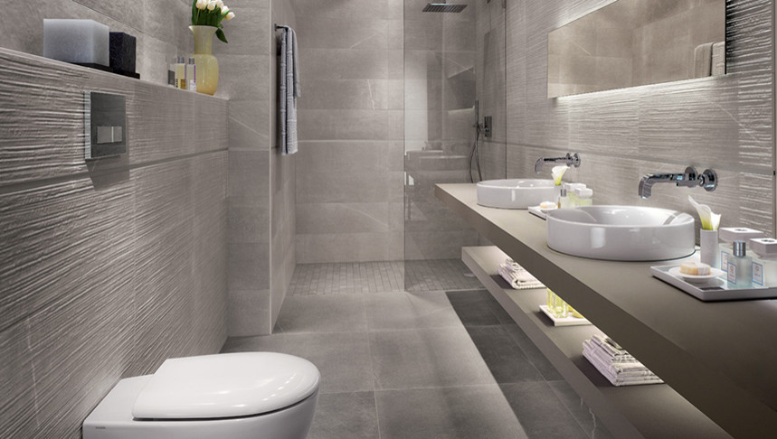 This is an example of a mid-sized contemporary master bathroom in Toronto with open cabinets, grey cabinets, an open shower, a bidet, gray tile, porcelain tile, grey walls, cement tiles, a vessel sink and solid surface benchtops.