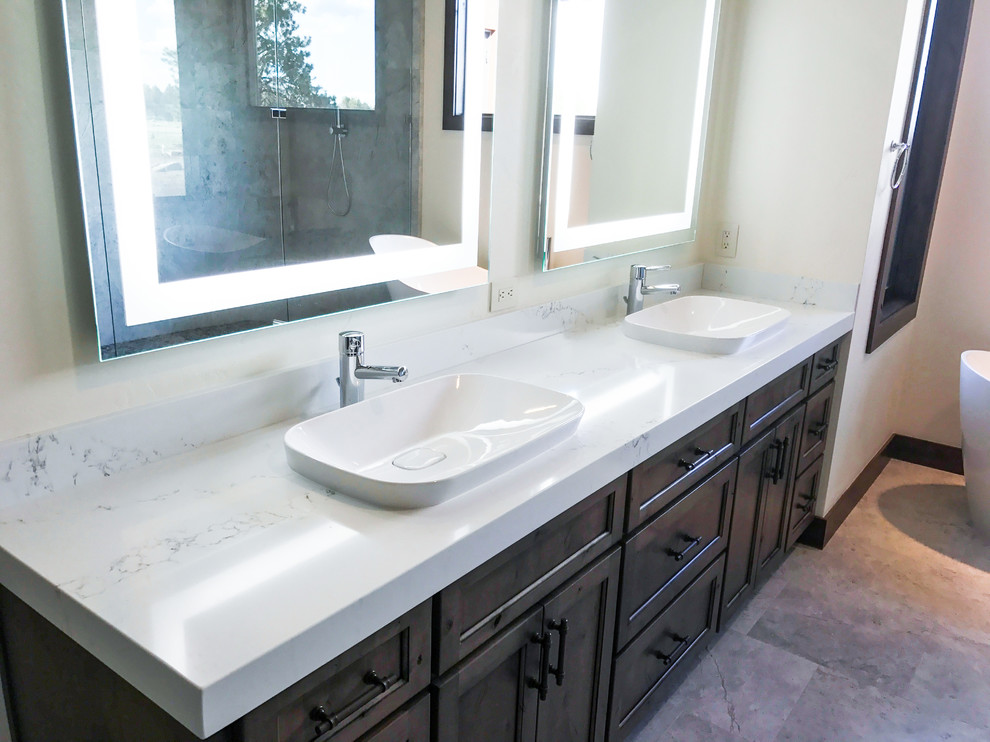 Inspiration for a large transitional master white tile and marble tile travertine floor and beige floor freestanding bathtub remodel with shaker cabinets, dark wood cabinets, beige walls, a drop-in sink, marble countertops and a hinged shower door