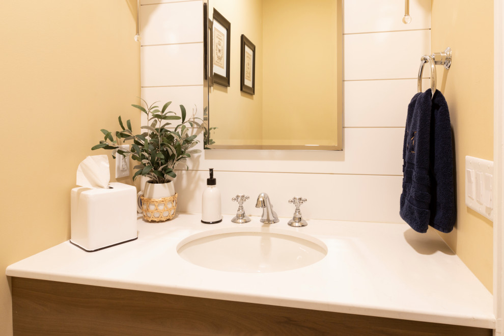 Kleine Klassische Gästetoilette mit gelber Wandfarbe, Unterbauwaschbecken, Quarzwerkstein-Waschtisch, weißer Waschtischplatte und schwebendem Waschtisch in New York