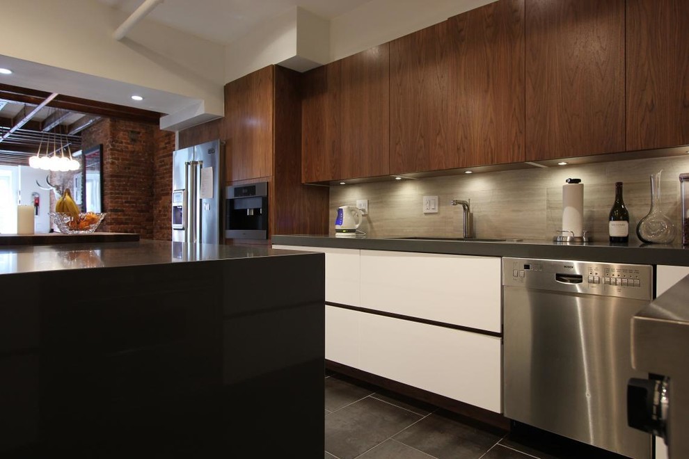 Photo of a small modern l-shaped kitchen in New York with flat-panel cabinets, white cabinets, granite benchtops, grey splashback, stainless steel appliances and with island.
