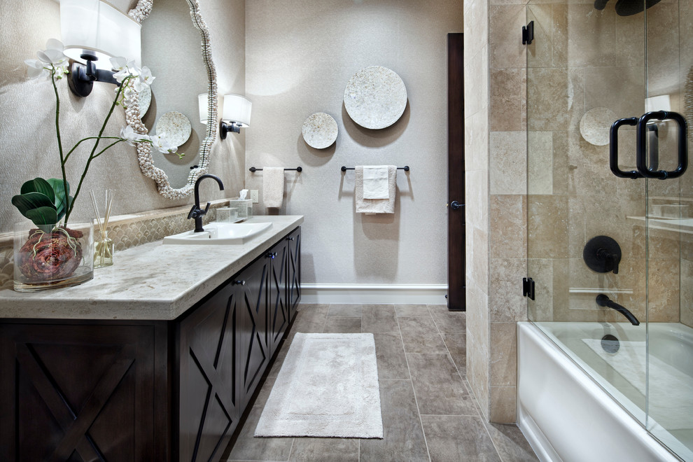 Photo of a mediterranean bathroom in Houston with a drop-in sink, recessed-panel cabinets, dark wood cabinets, a corner tub and an alcove shower.