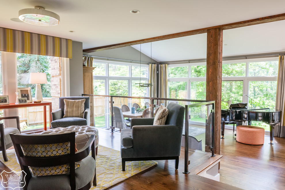 Inspiration for a large transitional medium tone wood floor and brown floor great room remodel with gray walls, a corner fireplace and a stone fireplace