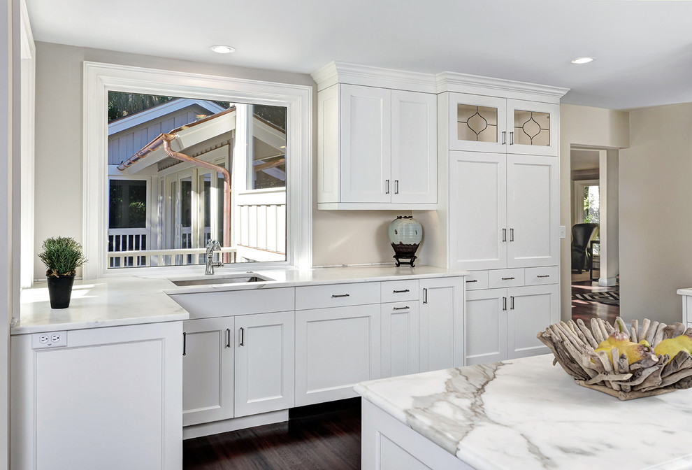 Inspiration for a transitional dark wood floor enclosed kitchen remodel in Charleston with an undermount sink, recessed-panel cabinets, white cabinets, granite countertops and an island