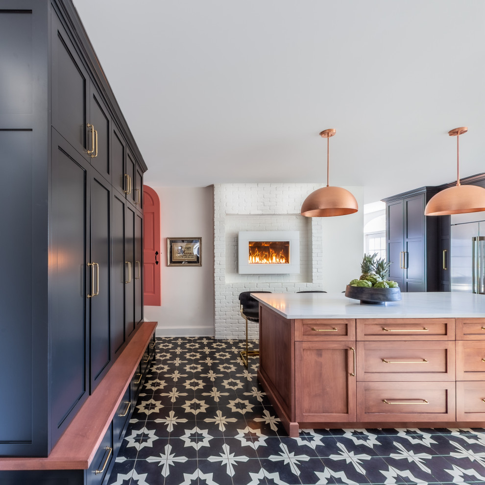 This is an example of a mid-sized eclectic u-shaped separate kitchen in Boston with a farmhouse sink, shaker cabinets, black cabinets, quartz benchtops, white splashback, ceramic splashback, stainless steel appliances, cement tiles, with island, multi-coloured floor, white benchtop and wood.
