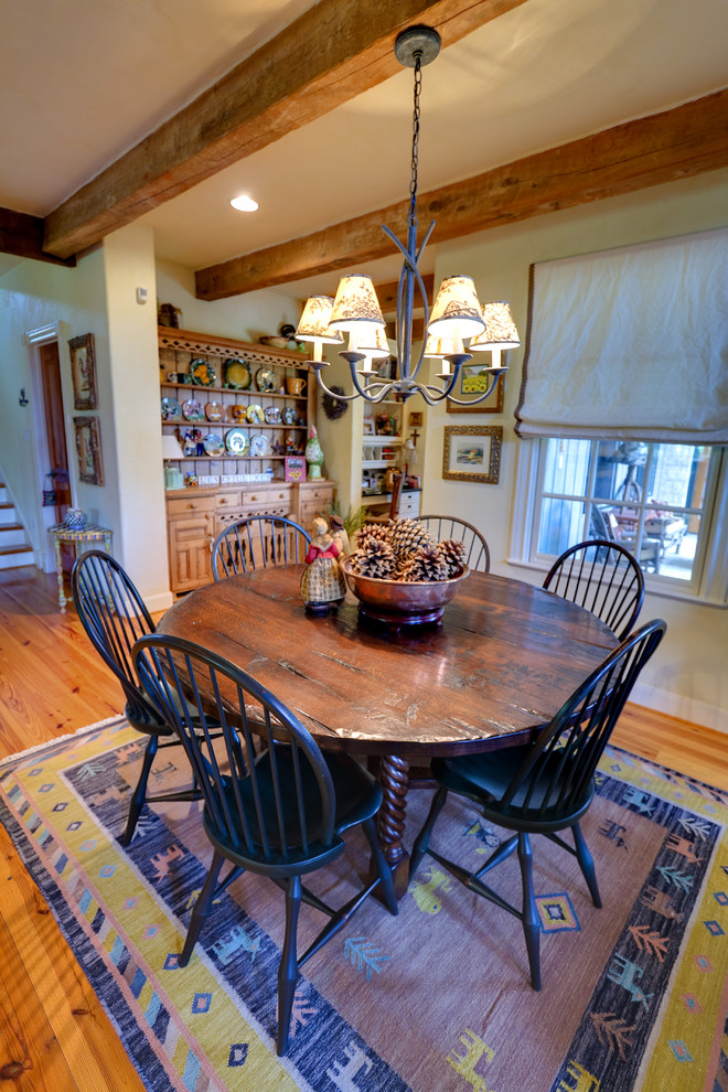 This is an example of a mid-sized country kitchen/dining combo in Austin with beige walls and light hardwood floors.