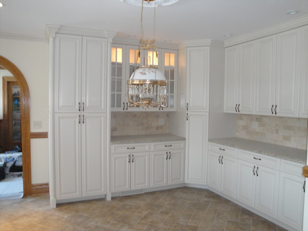 Photo of a small traditional l-shaped eat-in kitchen in New York with raised-panel cabinets, white cabinets, laminate benchtops, beige splashback, stone tile splashback, cement tiles, no island and beige floor.