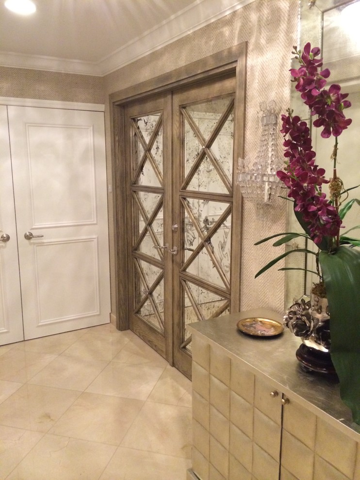 Photo of a mid-sized traditional hallway in Miami with beige walls, ceramic floors and beige floor.