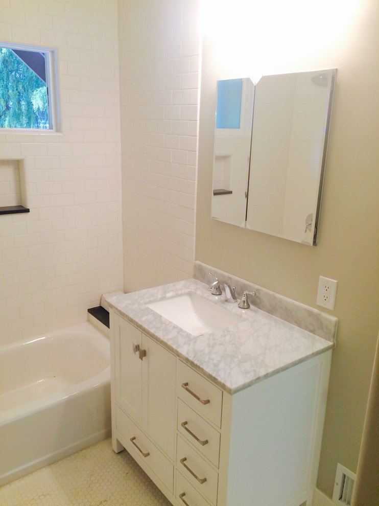 Photo of a small contemporary master bathroom in Los Angeles with flat-panel cabinets, white cabinets, a drop-in tub, a shower/bathtub combo, black and white tile, ceramic tile, grey walls, ceramic floors, a wall-mount sink, tile benchtops, white floor and a shower curtain.