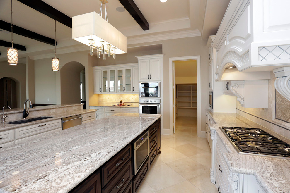 Example of a transitional marble floor eat-in kitchen design in Houston with an undermount sink, recessed-panel cabinets, white cabinets, granite countertops, stone tile backsplash, stainless steel appliances and two islands