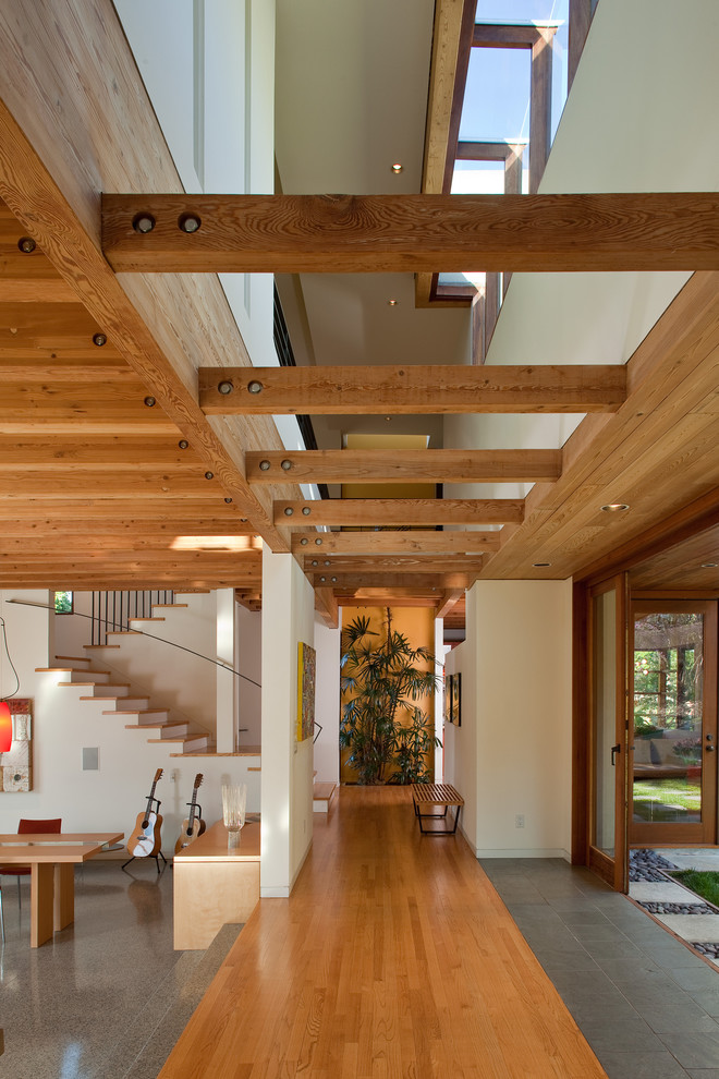 This is an example of a large contemporary hallway in San Francisco with white walls and medium hardwood floors.