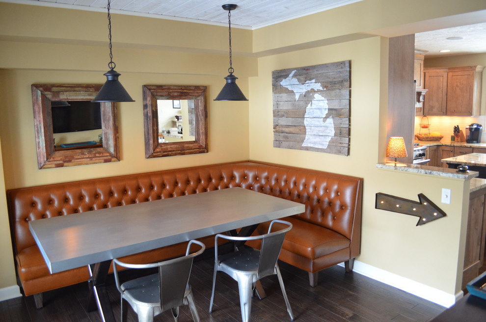 Mountain style l-shaped dark wood floor kitchen/dining room combo photo with an undermount sink, shaker cabinets, medium tone wood cabinets, laminate countertops, black backsplash, subway tile backsplash, stainless steel appliances and two islands