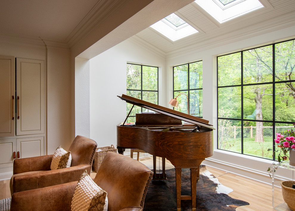 This is an example of a small country sunroom in Other with light hardwood floors, a skylight and brown floor.