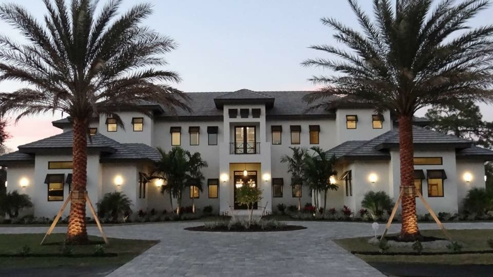 Design ideas for a large transitional two-storey stucco white exterior in Miami.
