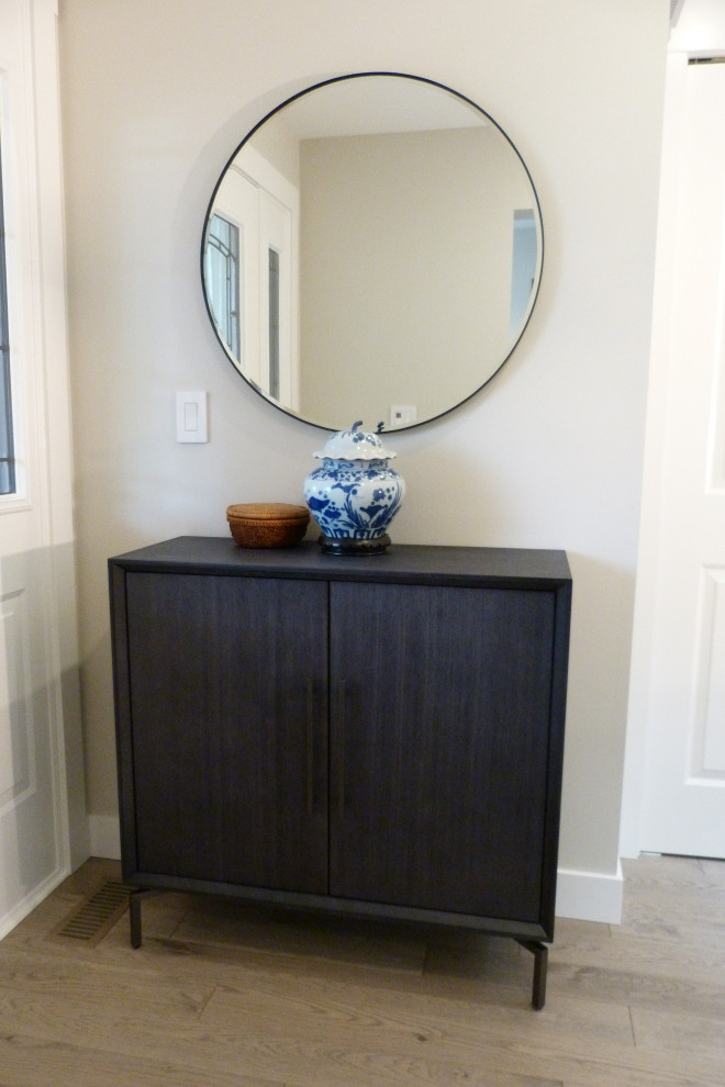 Inspiration for a small transitional light wood floor and beige floor entry hall remodel in Vancouver with gray walls and a white front door