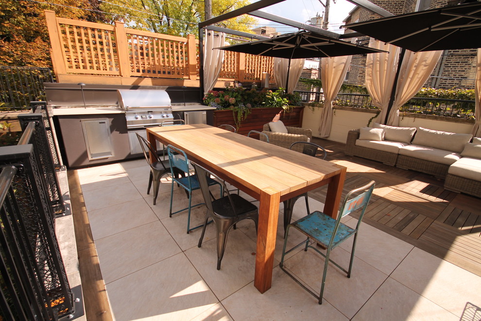 Photo of a mid-sized contemporary rooftop deck in Chicago with an outdoor kitchen and a pergola.