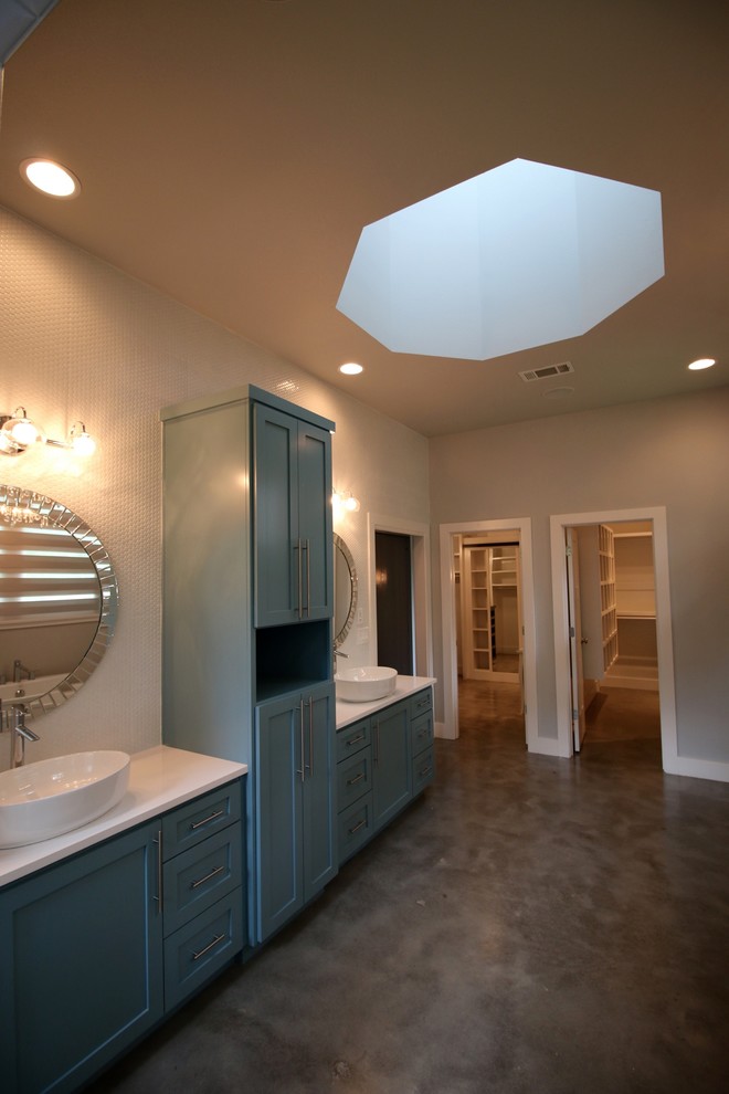 Inspiration for a large transitional master bathroom in Other with shaker cabinets, blue cabinets, a freestanding tub, white tile, mosaic tile, beige walls, concrete floors, a vessel sink, solid surface benchtops, grey floor and white benchtops.