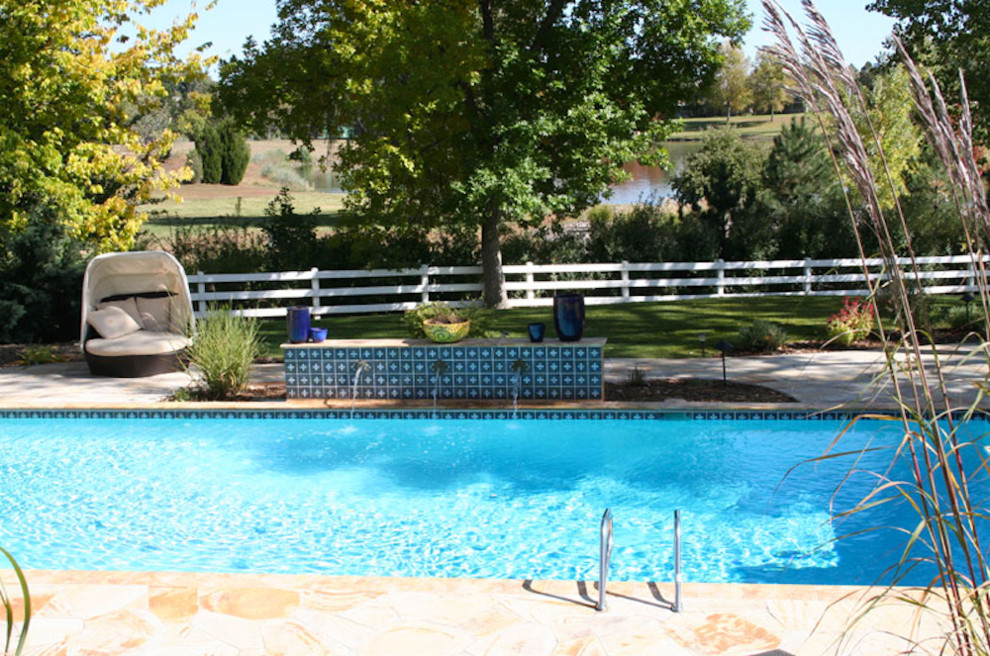 Photo of a mid-sized traditional backyard rectangular natural pool in Denver.
