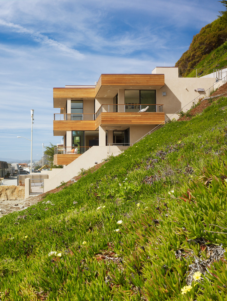 Mid-sized contemporary two-storey beige house exterior in San Francisco with wood siding and a flat roof.