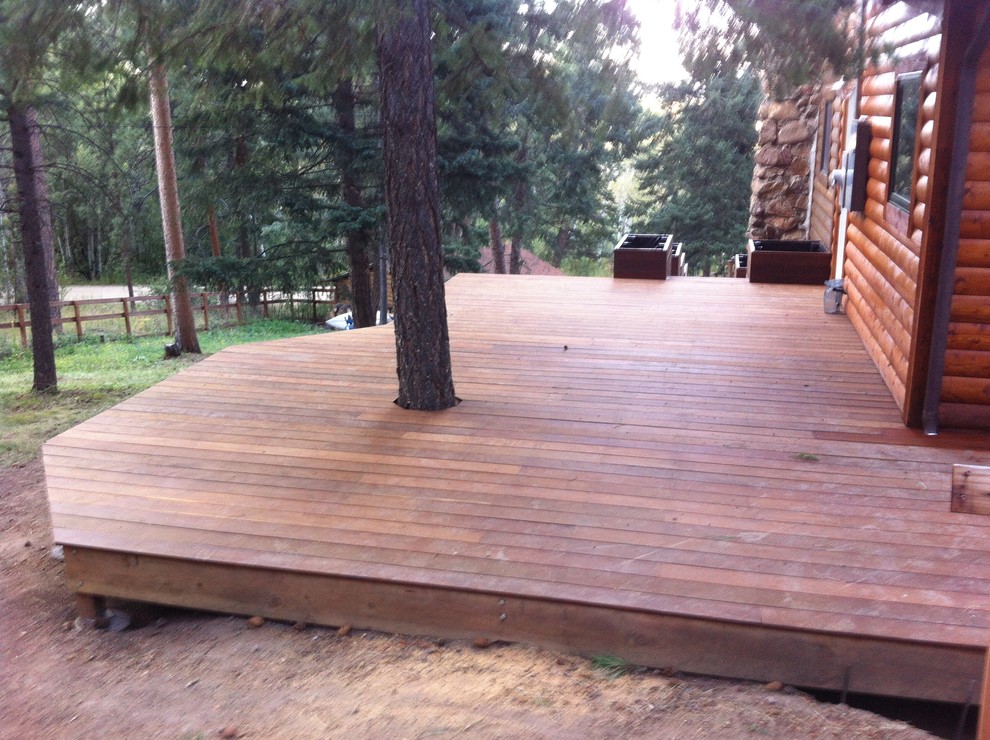 Large arts and crafts backyard deck in Denver with a container garden and no cover.