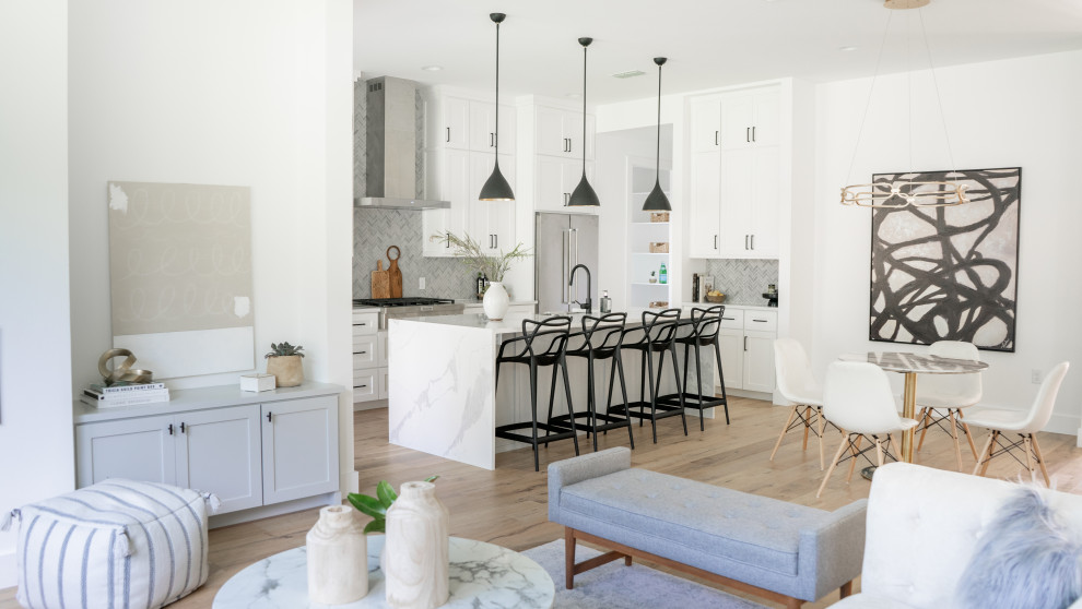 Inspiration for a transitional kitchen remodel in Austin with a farmhouse sink, shaker cabinets, white cabinets, quartz countertops, gray backsplash and stone tile backsplash