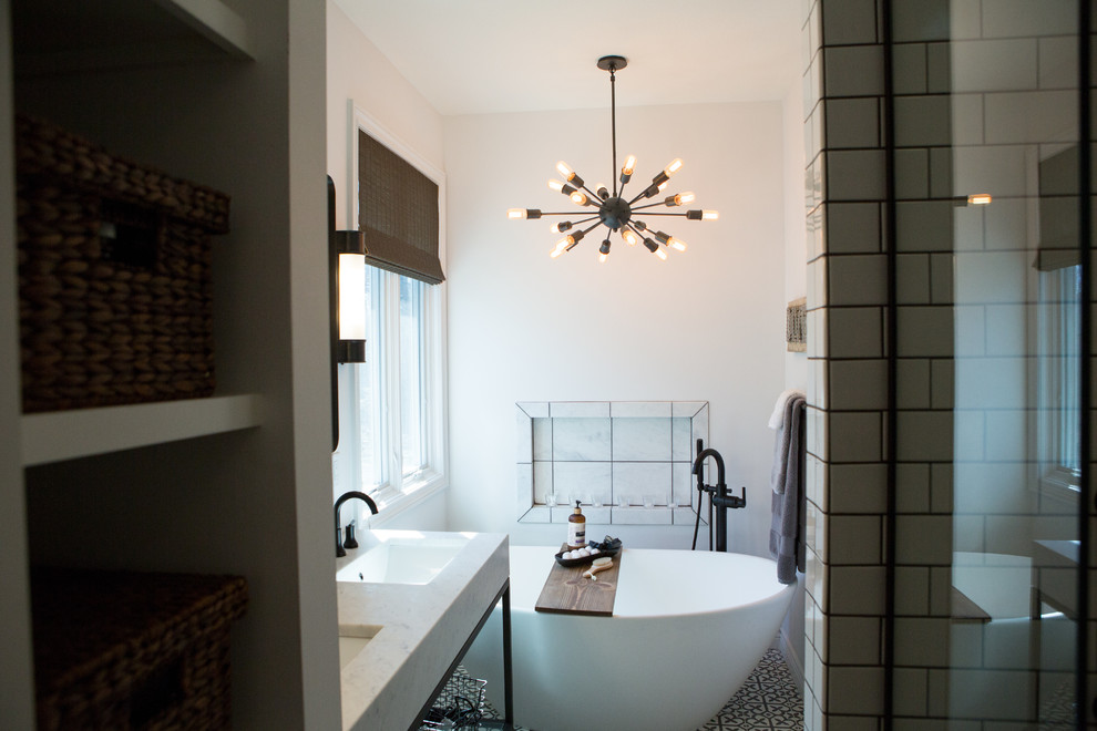 This is an example of a small eclectic master bathroom in Other with furniture-like cabinets, black cabinets, a freestanding tub, an open shower, white tile, ceramic tile, white walls, concrete floors, an undermount sink, marble benchtops, grey floor, an open shower and white benchtops.