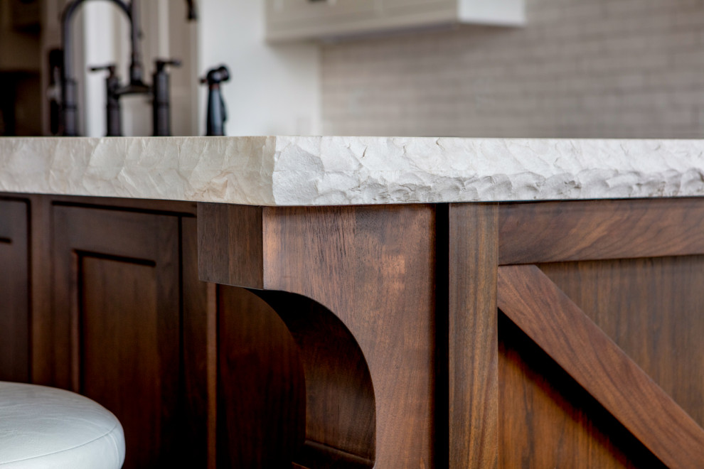Inspiration for a large rustic l-shaped light wood floor and beige floor eat-in kitchen remodel in Toronto with a farmhouse sink, shaker cabinets, white cabinets, quartz countertops, white backsplash, subway tile backsplash, paneled appliances, an island and white countertops