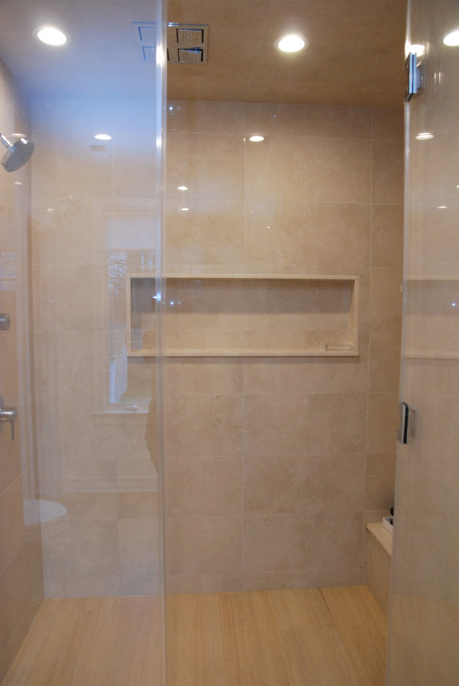 This is an example of a large modern master bathroom in New York with flat-panel cabinets, light wood cabinets, an alcove shower, beige tile, light hardwood floors, an undermount sink, a hinged shower door, beige benchtops, a shower seat, a double vanity, a floating vanity and coffered.