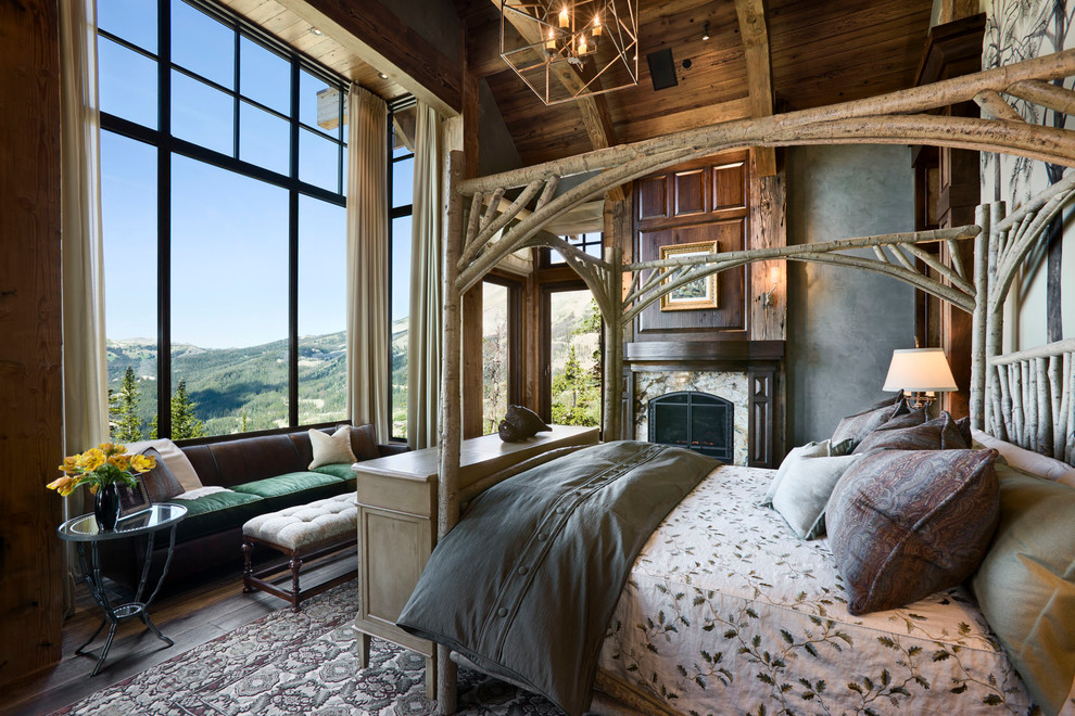 Inspiration for a country master bedroom in Other with grey walls, dark hardwood floors and a standard fireplace.