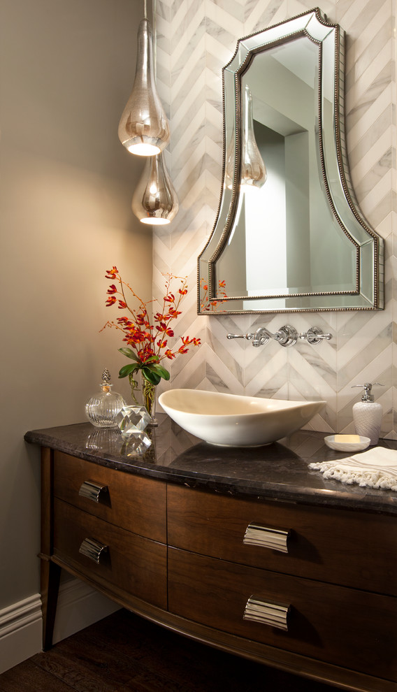 Inspiration for a mid-sized transitional powder room in San Diego with a vessel sink, furniture-like cabinets, dark wood cabinets, granite benchtops, gray tile, grey walls and dark hardwood floors.