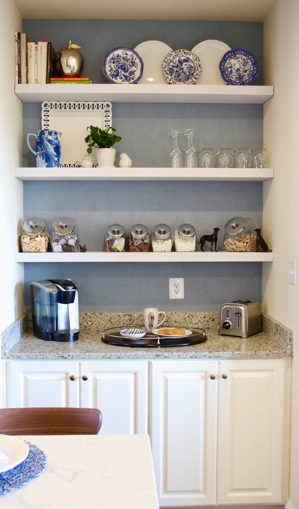 Example of a small transitional galley medium tone wood floor open concept kitchen design in Baltimore with a farmhouse sink, raised-panel cabinets, white cabinets, granite countertops, blue backsplash, an island and beige countertops