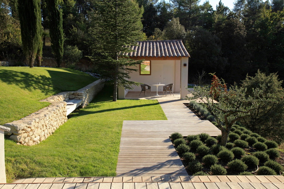 This is an example of a mid-sized contemporary patio in Marseille with decking and a gazebo/cabana.