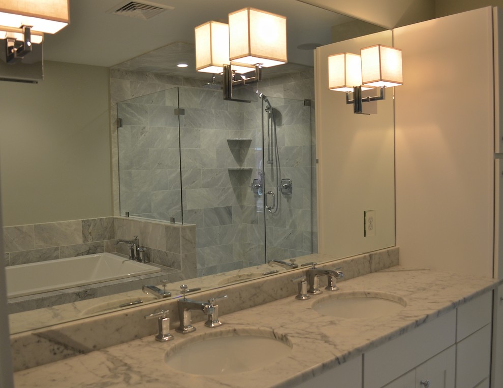 Inspiration for a mid-sized contemporary master bathroom in Providence with shaker cabinets, white cabinets, a drop-in tub, a corner shower, gray tile, white tile, beige walls, porcelain floors, an undermount sink, quartzite benchtops, grey floor and a hinged shower door.