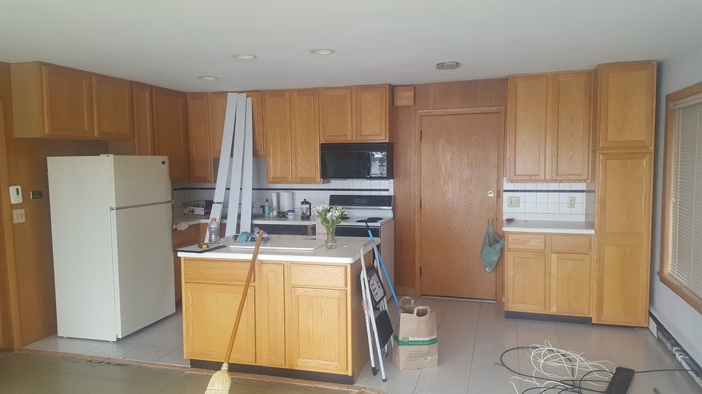 Kitchen - transitional vinyl floor kitchen idea with an undermount sink, white cabinets, granite countertops, stainless steel appliances and no island