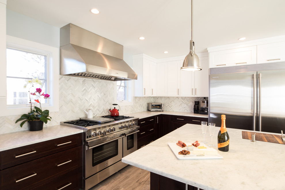 Inspiration for a mid-sized transitional l-shaped light wood floor and beige floor open concept kitchen remodel in Chicago with a single-bowl sink, shaker cabinets, white cabinets, marble countertops, gray backsplash, marble backsplash, stainless steel appliances and an island