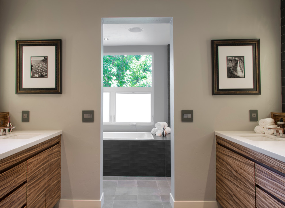 Inspiration for a modern master bathroom in San Diego with flat-panel cabinets, medium wood cabinets, a drop-in tub, a corner shower, gray tile, white tile, porcelain tile, grey walls, porcelain floors, an undermount sink and engineered quartz benchtops.