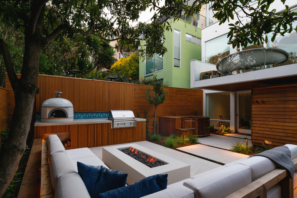 Example of a small trendy backyard concrete paver patio design in San Francisco with a fire pit