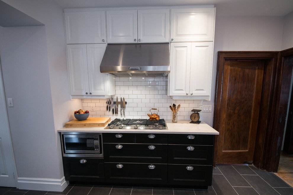 Home design - transitional galley home design idea in Ottawa with recessed-panel cabinets, black cabinets, quartzite countertops, white backsplash, stainless steel appliances and no island