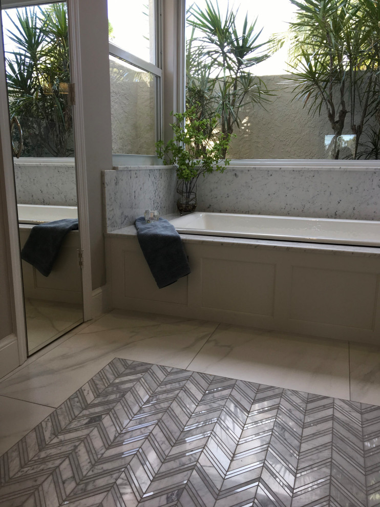 Example of a mid-sized transitional master gray tile and porcelain tile porcelain tile, gray floor, double-sink and vaulted ceiling bathroom design in Miami with shaker cabinets, white cabinets, a two-piece toilet, gray walls, an undermount sink, marble countertops, white countertops and a freestanding vanity