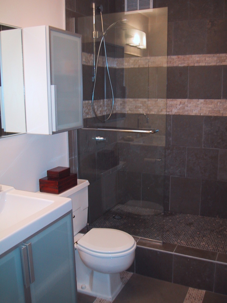 This is an example of a small contemporary master bathroom in Hawaii with an integrated sink, glass-front cabinets, an open shower, gray tile, stone tile, white walls and slate floors.