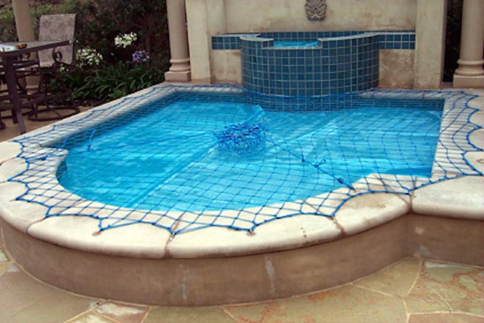 Inspiration for a mid-sized backyard stone and custom-shaped hot tub remodel in Miami