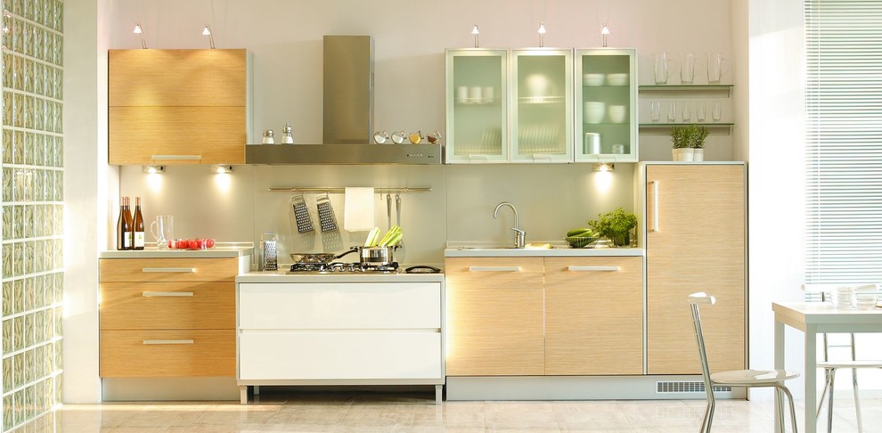 Photo of a small modern single-wall open plan kitchen in Other with an undermount sink, flat-panel cabinets, light wood cabinets, quartz benchtops, beige splashback, glass sheet splashback, no island and beige floor.