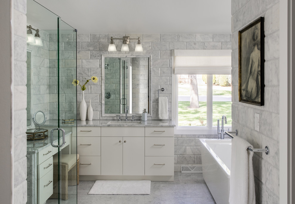 This is an example of a mid-sized midcentury master wet room bathroom in Denver with flat-panel cabinets, white cabinets, a freestanding tub, gray tile, marble, grey walls, marble floors, a drop-in sink, marble benchtops, grey floor, a hinged shower door and grey benchtops.