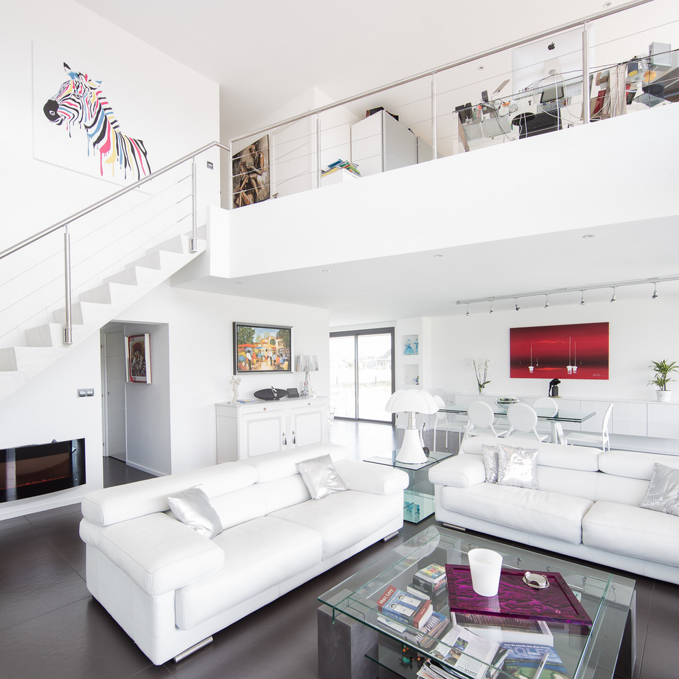 This is an example of a large contemporary formal living room in Lille with white walls, no tv and a ribbon fireplace.
