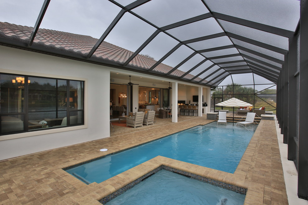 Inspiration for an eclectic indoor rectangular pool in Orlando with brick pavers.