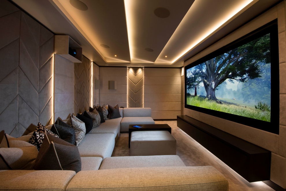 This is an example of a small contemporary enclosed home theatre in Cheshire with beige walls, carpet, a projector screen and beige floor.