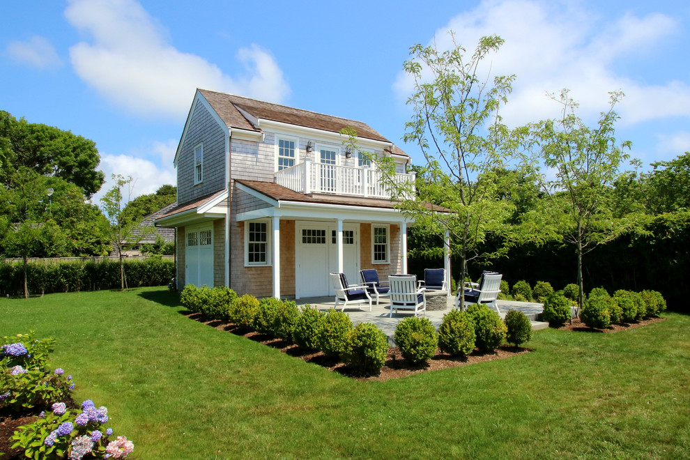 Expansive beach style two-storey grey exterior in Boston with wood siding and a hip roof.